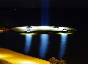 A nighttime photo of the 'sheboygan ufo landing pad,' featuring illuminated landing lights strategically placed along the lake michigan shoreline under a starry sky.