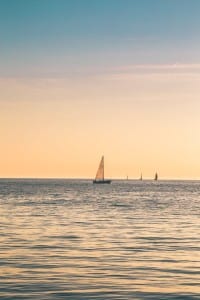 Beige sailboat under clear skies