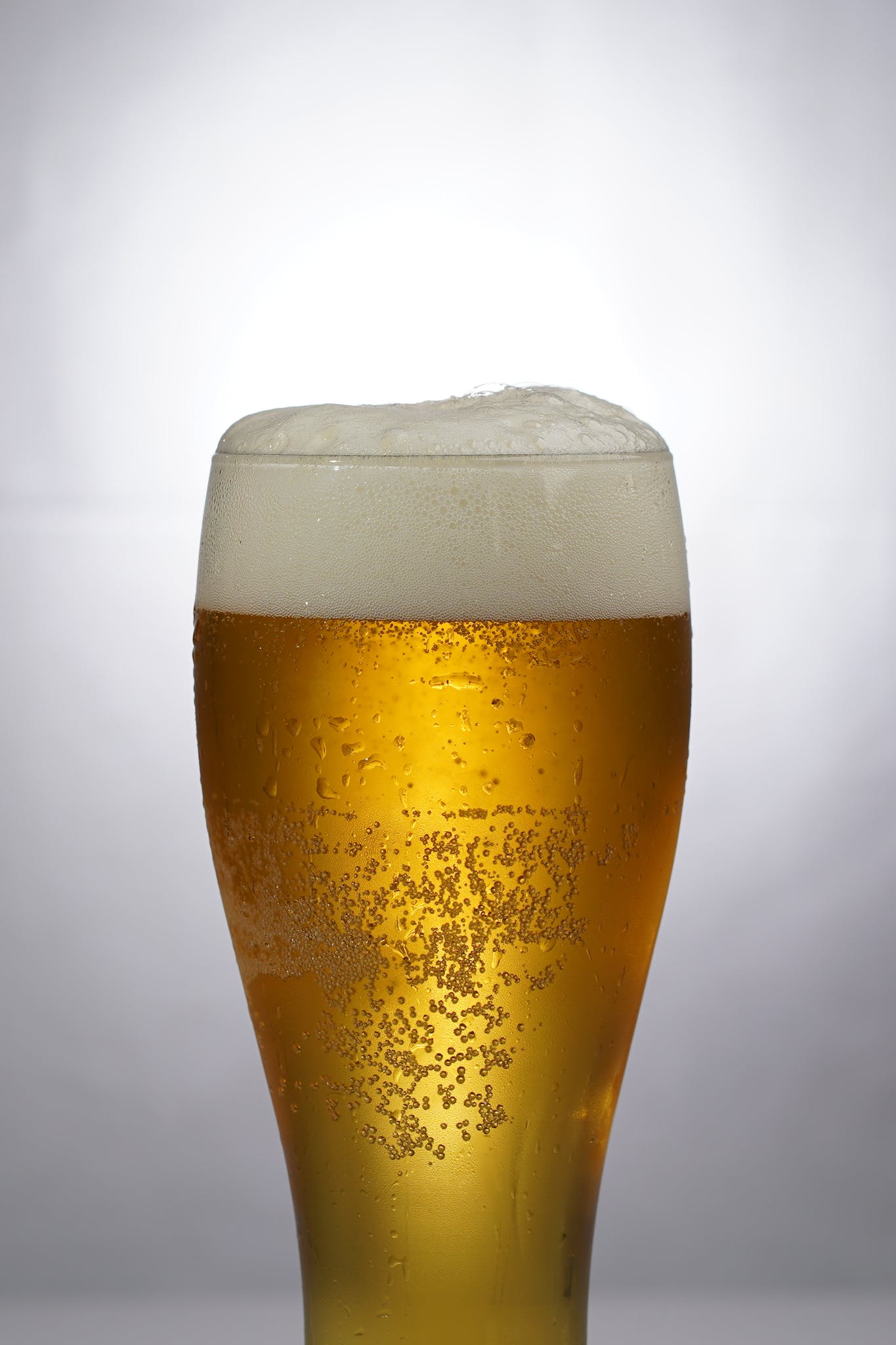 Clear drinking glass with beer and foam