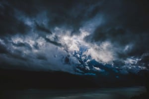 Dramatic clouds over river at night