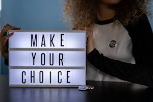 Woman with a make your choice voting sign