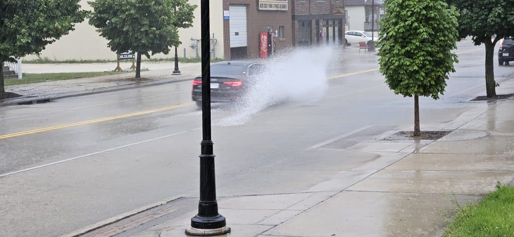 Cars splash through shallow floodwater at 11th & Indiana Ave during a 20‑minute summer downpour that overwhelmed storm drains—but receded just as fast when the rain let up.