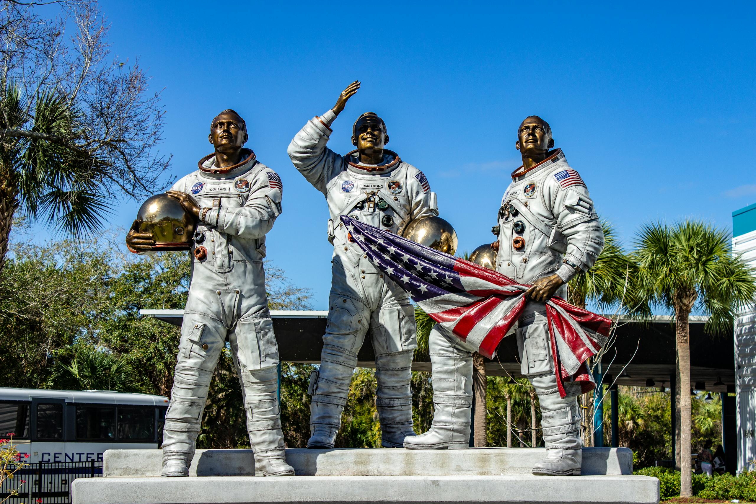 Statue of Apollo astronauts holding an American flag at Kennedy Space Center, Florida.
